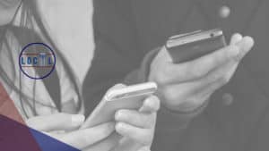 Two people are holding their cell phones.